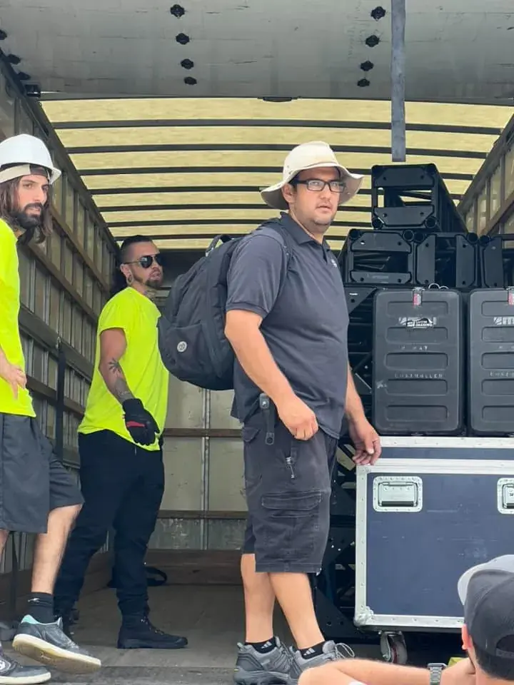 Logistics crew packing and securing gear in a truck trailer