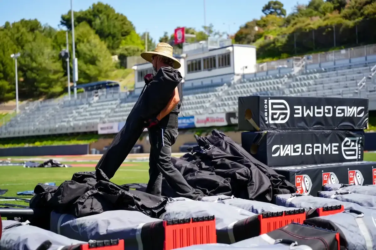 Crew loading stage equipment at a stadium event in San Diego