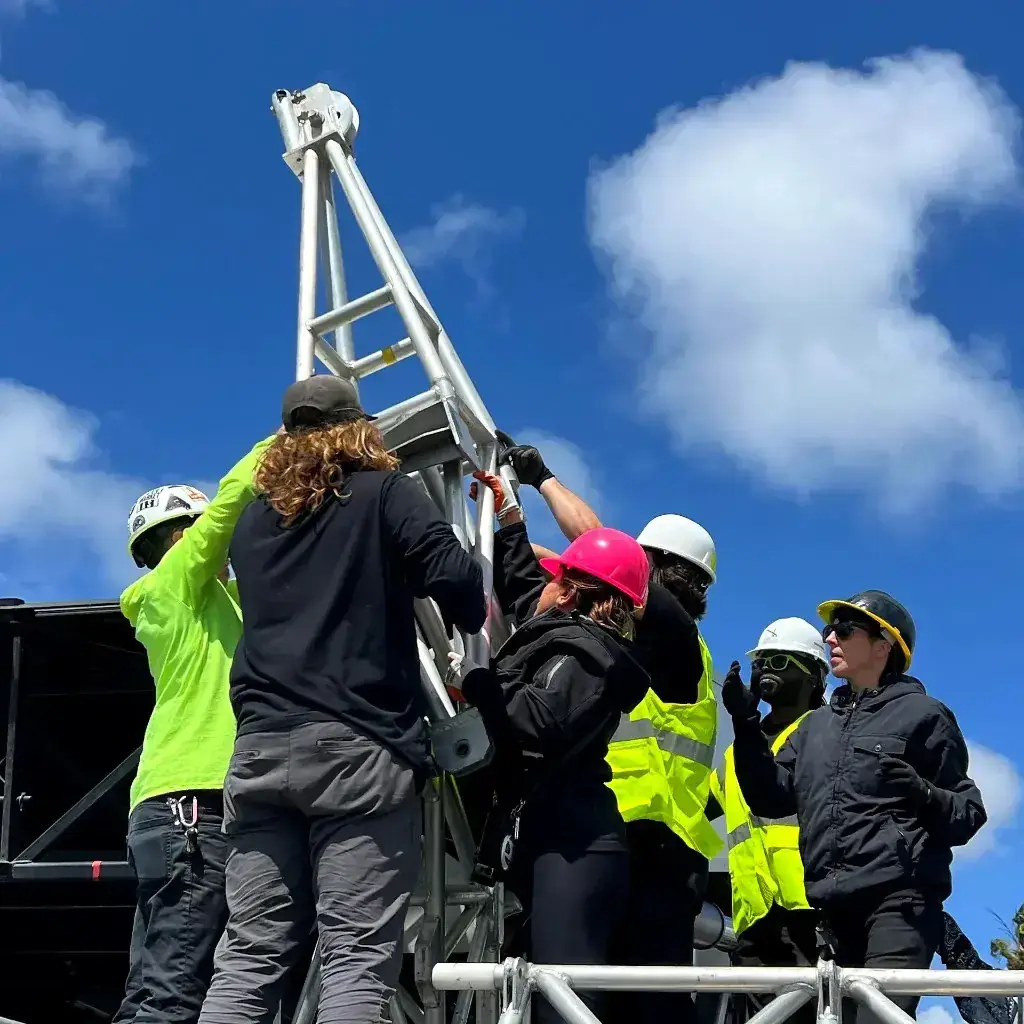 Professional stagehands setting up event rigging and trussing