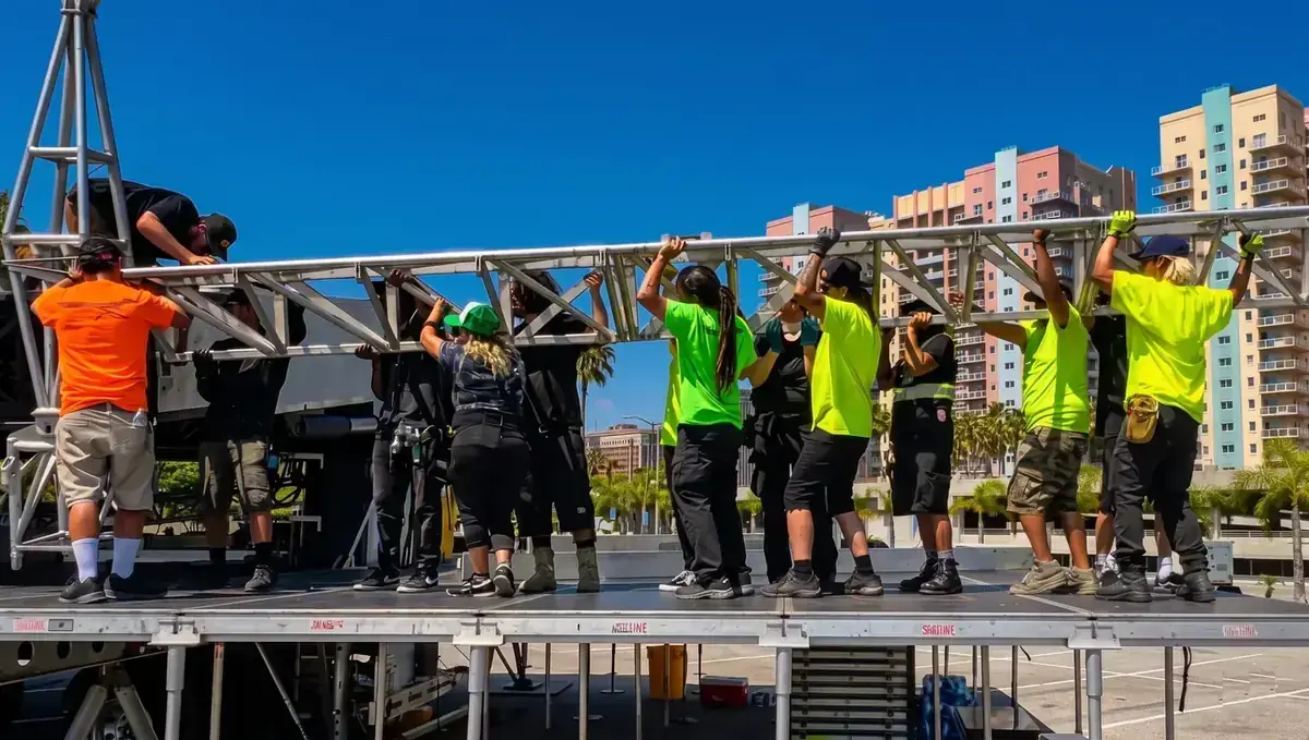 Event Production Concert Stage Crew Event Production Concert Stage Crew setting up outdoor event - Hands On Labor