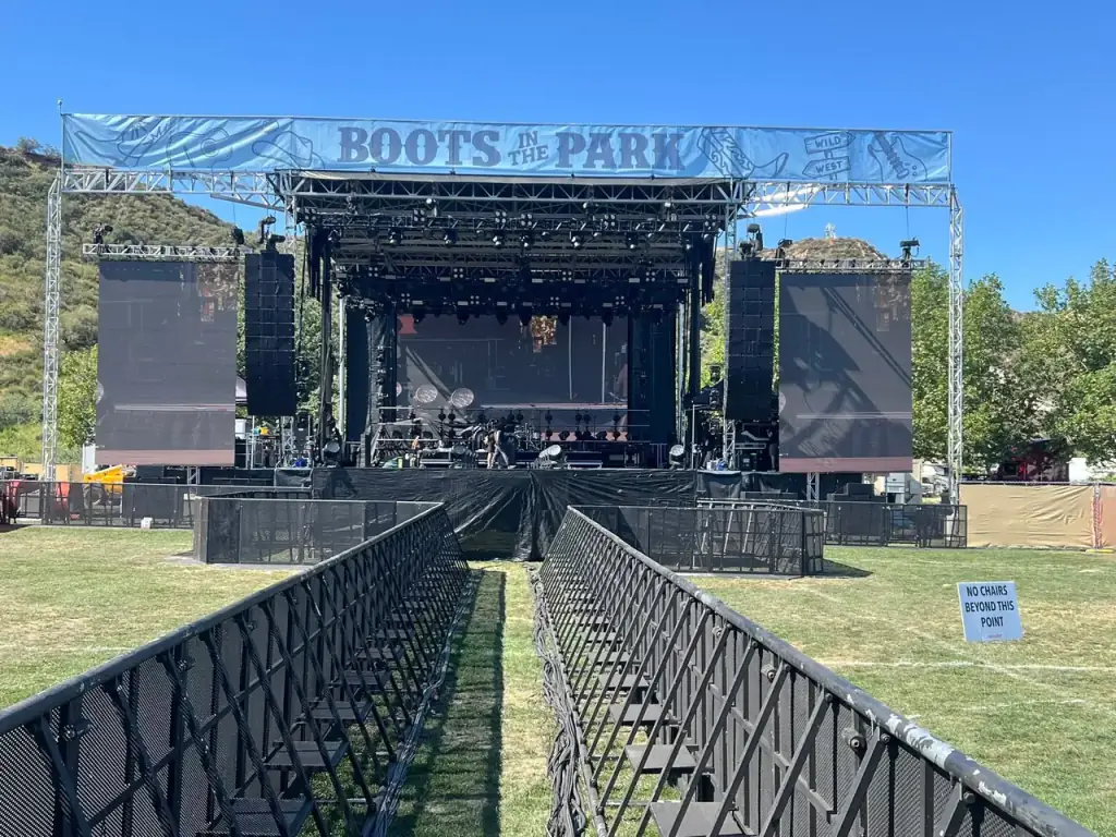 Complete interlocking steel crowd control barricade perimeter erected by event support crew at Waterfront Park