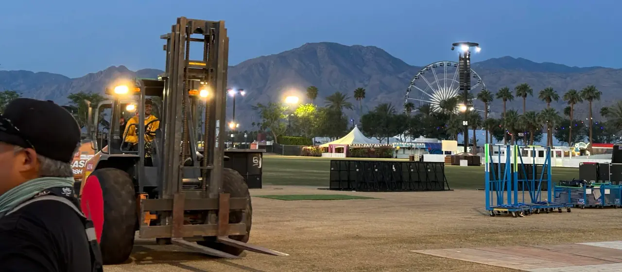 Forklift operations on festival grounds at Coachella Certified forklift operator driving heavy machinery on festival grounds at Coachella - Hands On Labor